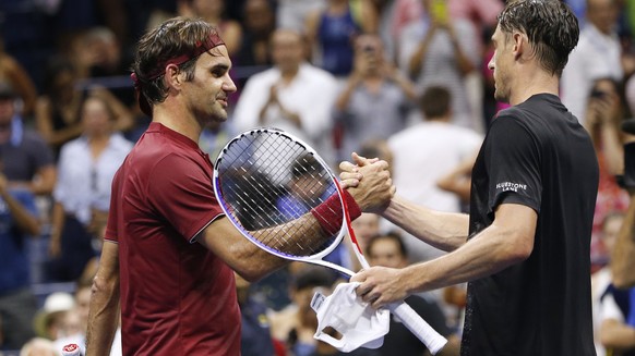 Roger Federer, of Switzerland, left, shakes hands with John Millman, of Australia, after losing during the fourth round of the U.S. Open tennis tournament early Tuesday, Sept. 4, 2018, in New York. (A ...