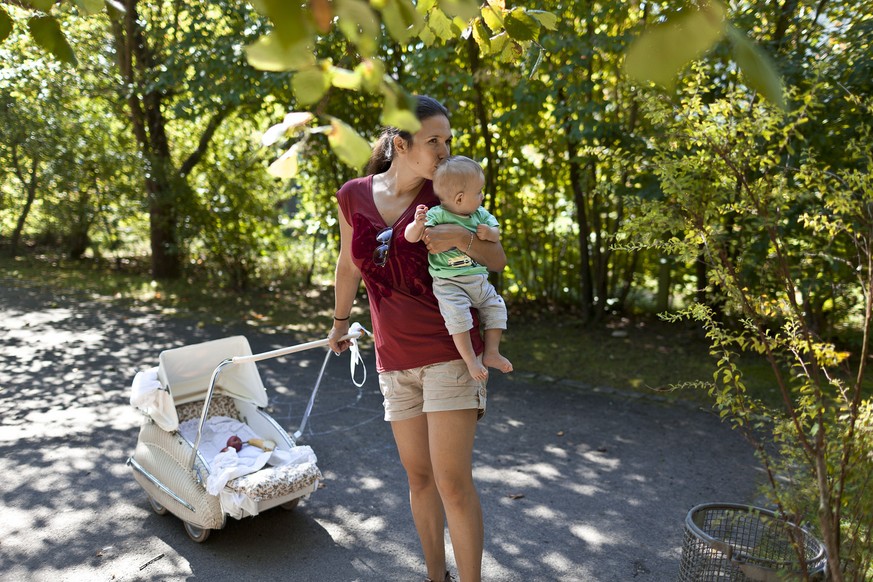 A mother kisses her six-month-old son Moris, pictured on September 16, 2011, in Unterfelden in the canton of Aargau, Switzerland. (KEYSTONE/Gaetan Bally)