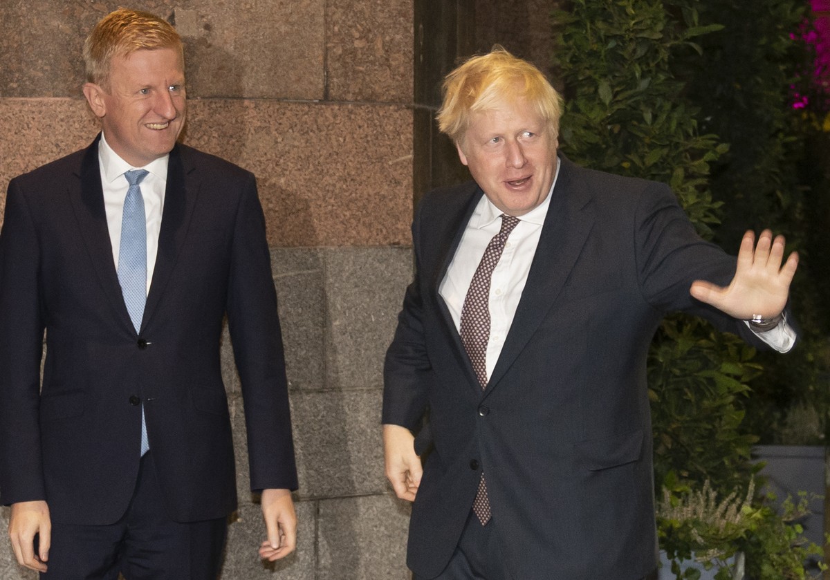 FILE - Britain's Prime Minister Boris Johnson, right, stands alongside Conservative Party Chairman Oliver Dowden as he arrives for the Conservative Party Conference in Manchester, England, Saturd ...