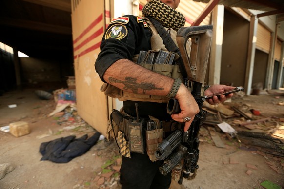 An Iraqi special forces soldier stands beside a store used by Islamic State militants in Bartilla, east of Mosul, Iraq October 27, 2016. REUTERS/Zohra Bensemra