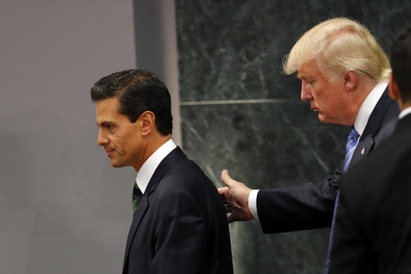 Republican presidential nominee Donald Trump walks with Mexico President Enrique Pena Nieto at the end of their joint statement at Los Pinos, the presidential official residence, in Mexico City, Wedne ...