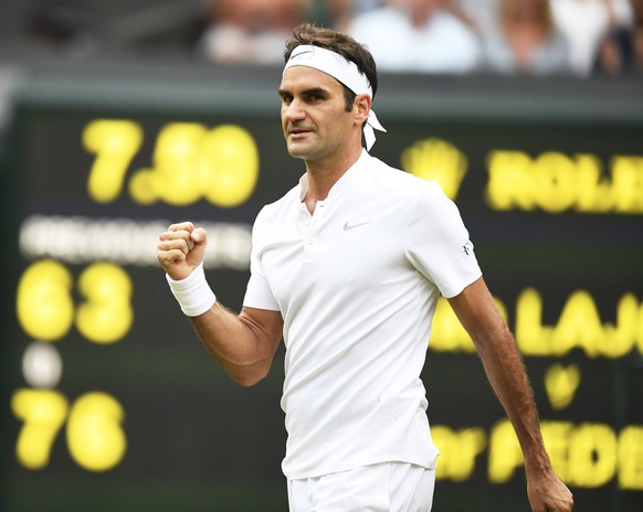 epa06071177 Roger Federer of Switzerland celebrates his win over Dusan Lajovic of Serbia in their second round match during the Wimbledon Championships at the All England Lawn Tennis Club, in London,  ...