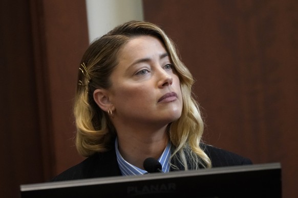 epa09926972 Actress Amber Heard listens as she testifies during the Depp v Heard defamation case at Fairfax County Circuit Court, in Fairfax, Virginia, USA, 04 May 2022. Johnny Depp&#039;s 50 million  ...