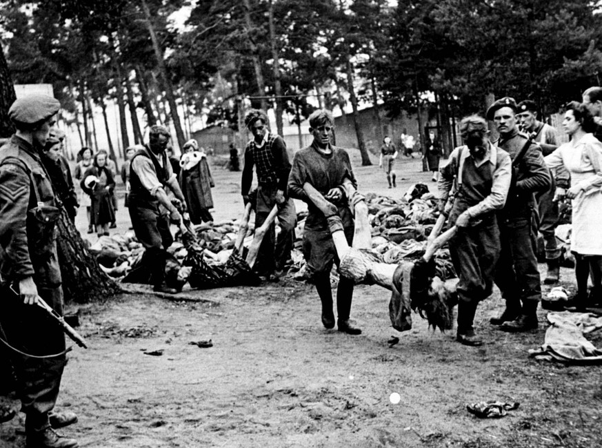 PA photo dated May 1945 of German SS men captured at Belsen concentration camp forced by Allied troops to carry the dead bodies of their victims. Some 10,000 guests from around the world are expected  ...