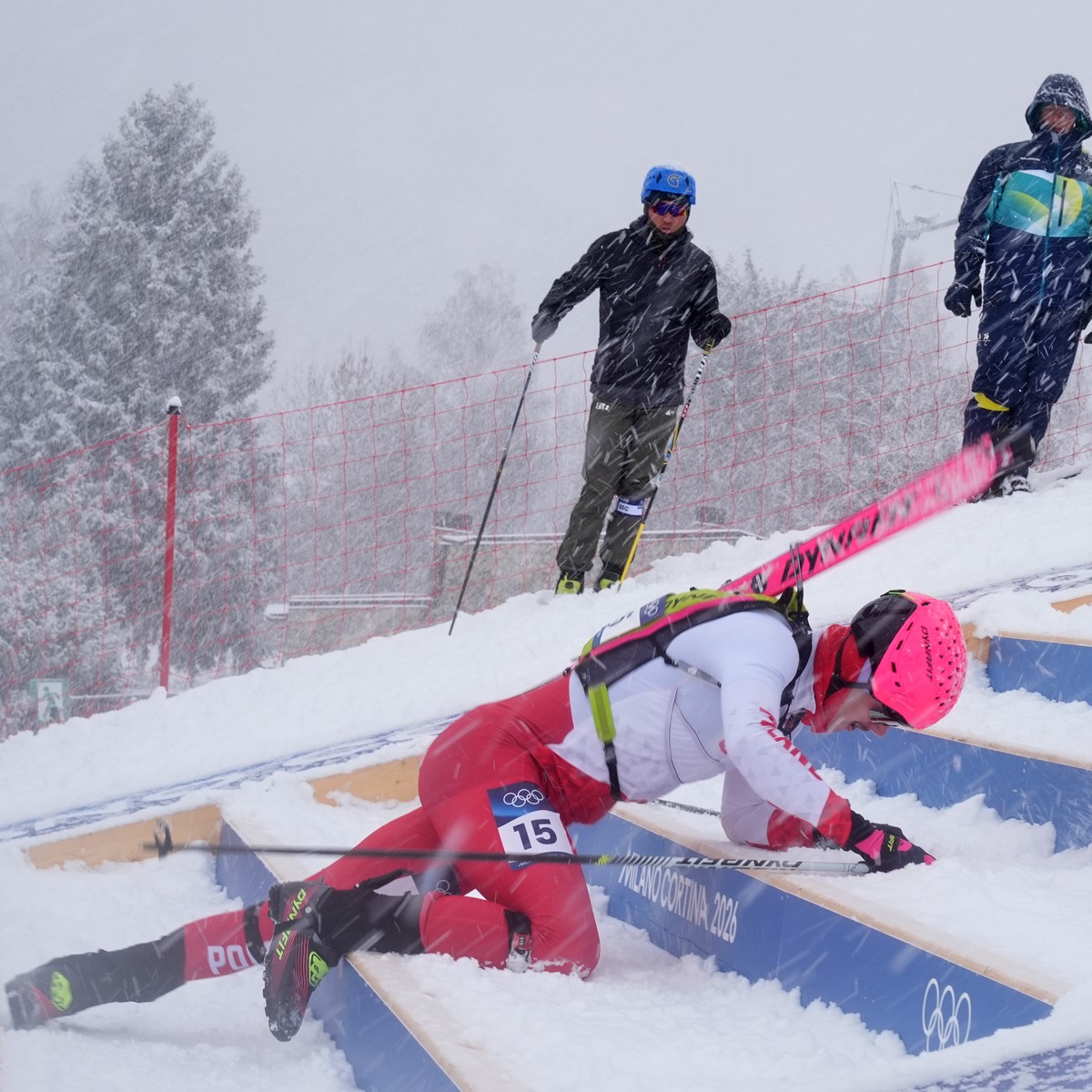 Poland's Jan Elantkowski falls as he competes during a ski mountaineering men's sprint heat, at the 2026 Winter Olympics, in Bormio, Italy, Thursday, Feb. 19, 2026. (AP Photo/Rebecca Blackwe ...