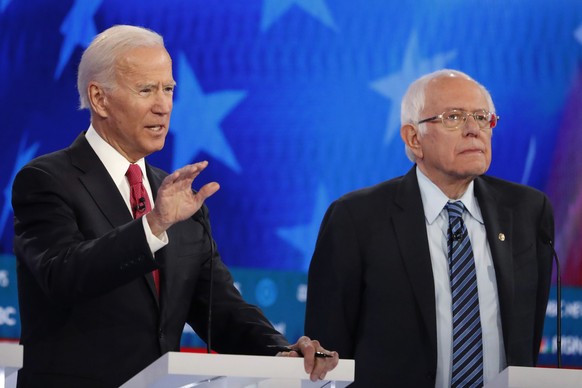 Democratic presidential candidate former Vice President Joe Biden, left, speaks as Democratic presidential candidate Sen. Bernie Sanders, I-Vt., listens during a Democratic presidential primary debate ...