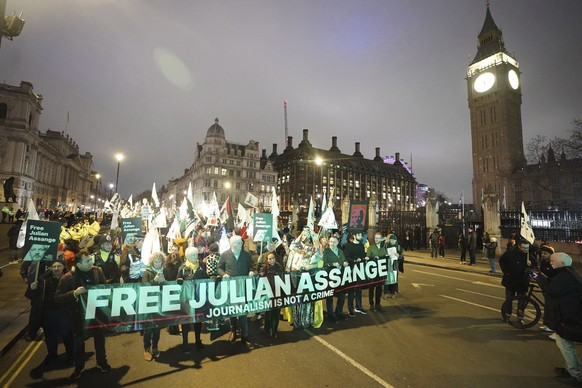 Campaigners pressing for the release of WikiLeaks founder Julian Assange take part in a demonstration during a Night Carnival in Parliament Square, London, Saturday, Feb. 11, 2023. (James Manning/PA v ...