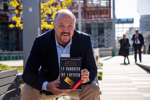 epa07079206 US former UBS Group AG banker and whistleblower Bradley Birkenfeld poses with his book at Paris courthouse in Paris, France, 08 October 2018 , prior to the trial of Swiss Bank UBS over all ...