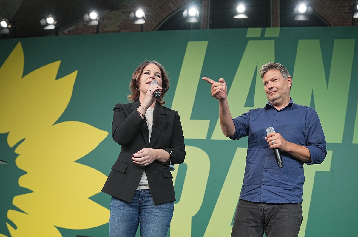 Annalena Baerbock, left, and Robert Habeck, federal leaders of the Greens, sit next to Robert Habeck, attend a congress in Berlin, Germany, Sunday, Oct. 17, 2021. Germany's Green party is decidin ...