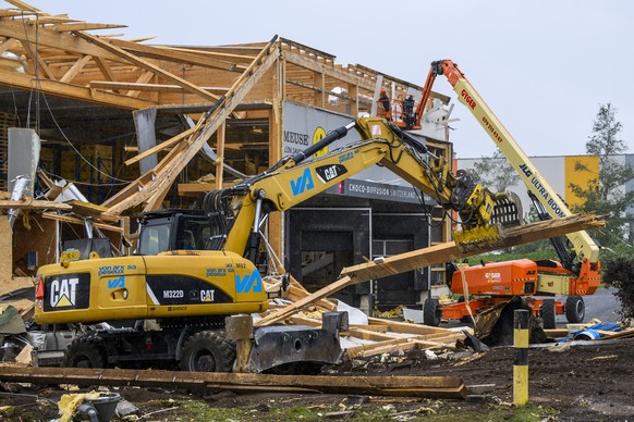 Des ouvriers enlevent les debris de l&#039;entreprise La Semeuse, un jour apres le passage de la forte tempete le mardi 25 juillet 2023 au Cret-du-Locle a cote de La Chaux-de-Fonds. Le deblaiement des ...