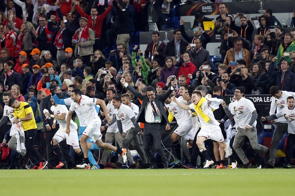 Player and staff from Sevilla celebrate their victory after the UEFA Europa League final between England&#039;s Liverpool FC and Spain&#039;s Sevilla Futbol Club at the St. Jakob-Park stadium in Basel ...