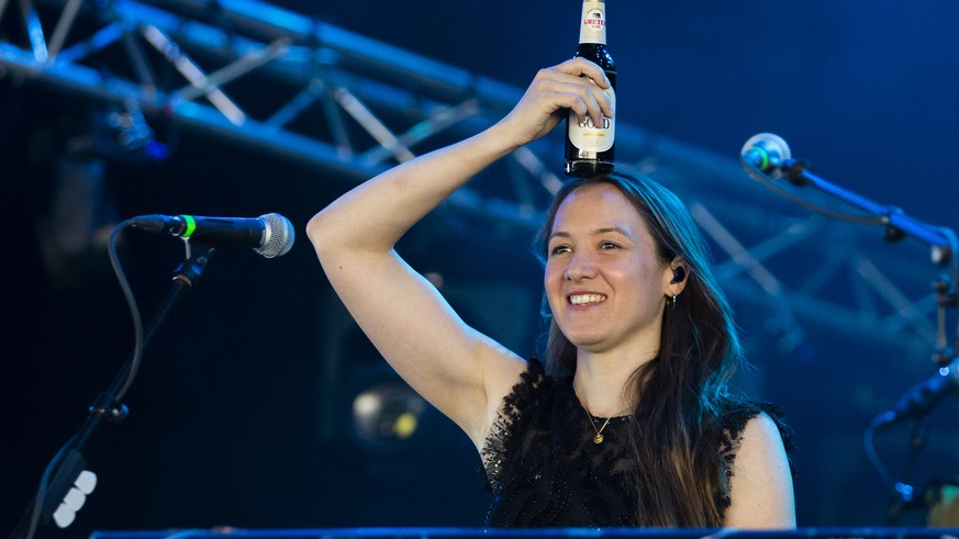 Swiss musician Sophie Hunger arrives on stage with a beer bottle, during the 36th edition of the Gurten music open air festival in Bern, Switzerland, Friday, July 19, 2019. The open air music festival ...