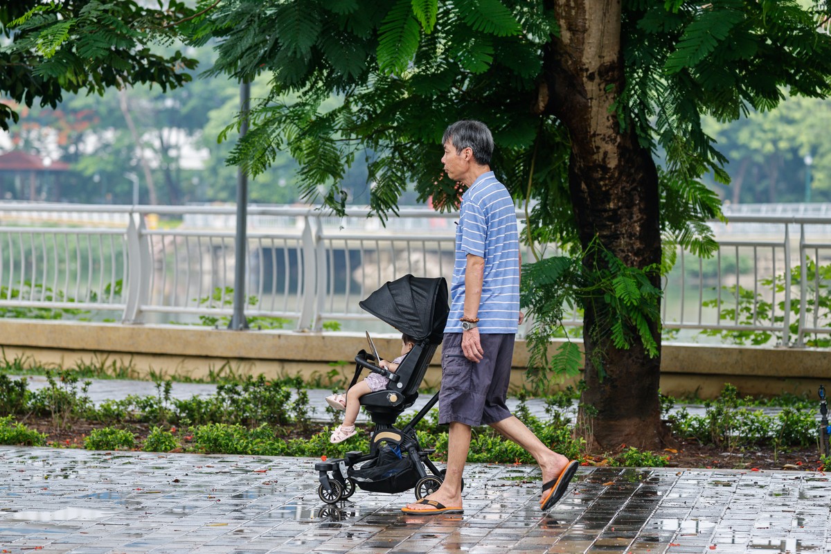 epa13101952 An elderly man with a baby carriage walks at a park in Hanoi, Vietnam, 10 July 2026. Vietnam has launched new incentives to encourage couples to have more children in response to the count ...