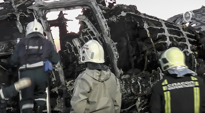 This image taken from a video distributed by Russian Investigative Committee on Monday, May 6, 2019, shows employees of the Russian Emergency Situations work at the wreckage of Sukhoi SSJ100 aircraft  ...