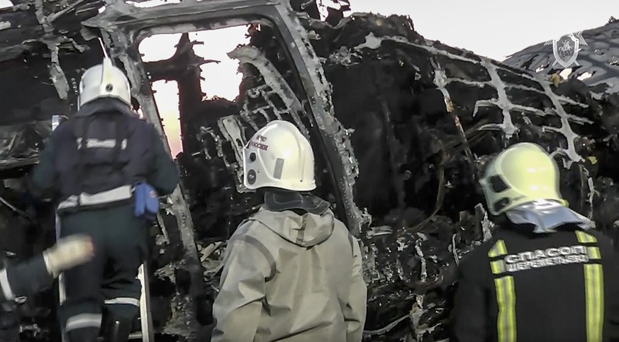 This image taken from a video distributed by Russian Investigative Committee on Monday, May 6, 2019, shows employees of the Russian Emergency Situations work at the wreckage of Sukhoi SSJ100 aircraft ...