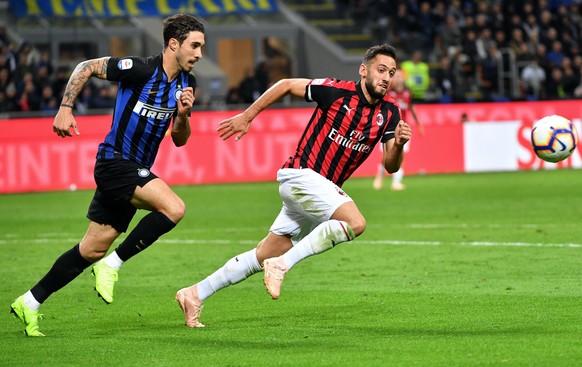 epa09293573 (FILE) - Milan&#039;s Hakan Calhanoglu (R) and Inter&#039;s Sime Vrsaljko (L) in action during the Italian Serie A soccer match between Inter Milan and AC Milan at Giuseppe Meazza stadium  ...