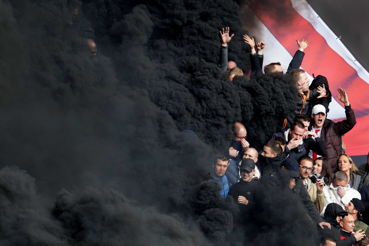 epa06255957 YEARENDER 2017 APRIL..Black smoke from a smoke bomb in the tribunes during the PSV vs Ajax KNVB Cup soccer match in Eindhoven, The Netherlands, 23 April 2017. The game was temporarily halt ...