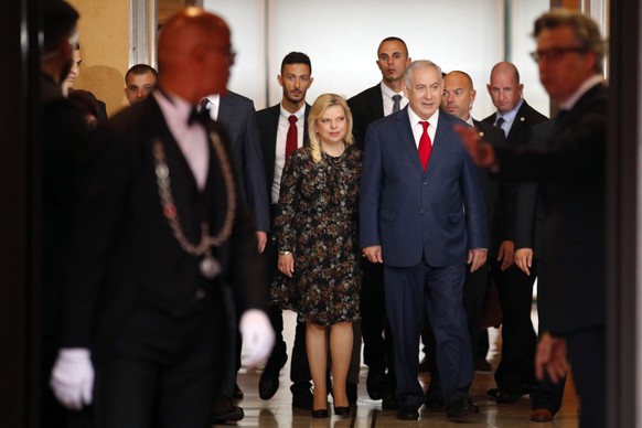 Israel&#039;s Prime Minister Benjamin Netanyahu and his wife Sara Netanyahu walk out after their meeting with French Finance Minister Bruno Le Maire at Bercy Economy Ministry, in Paris, Wednesday, Jun ...