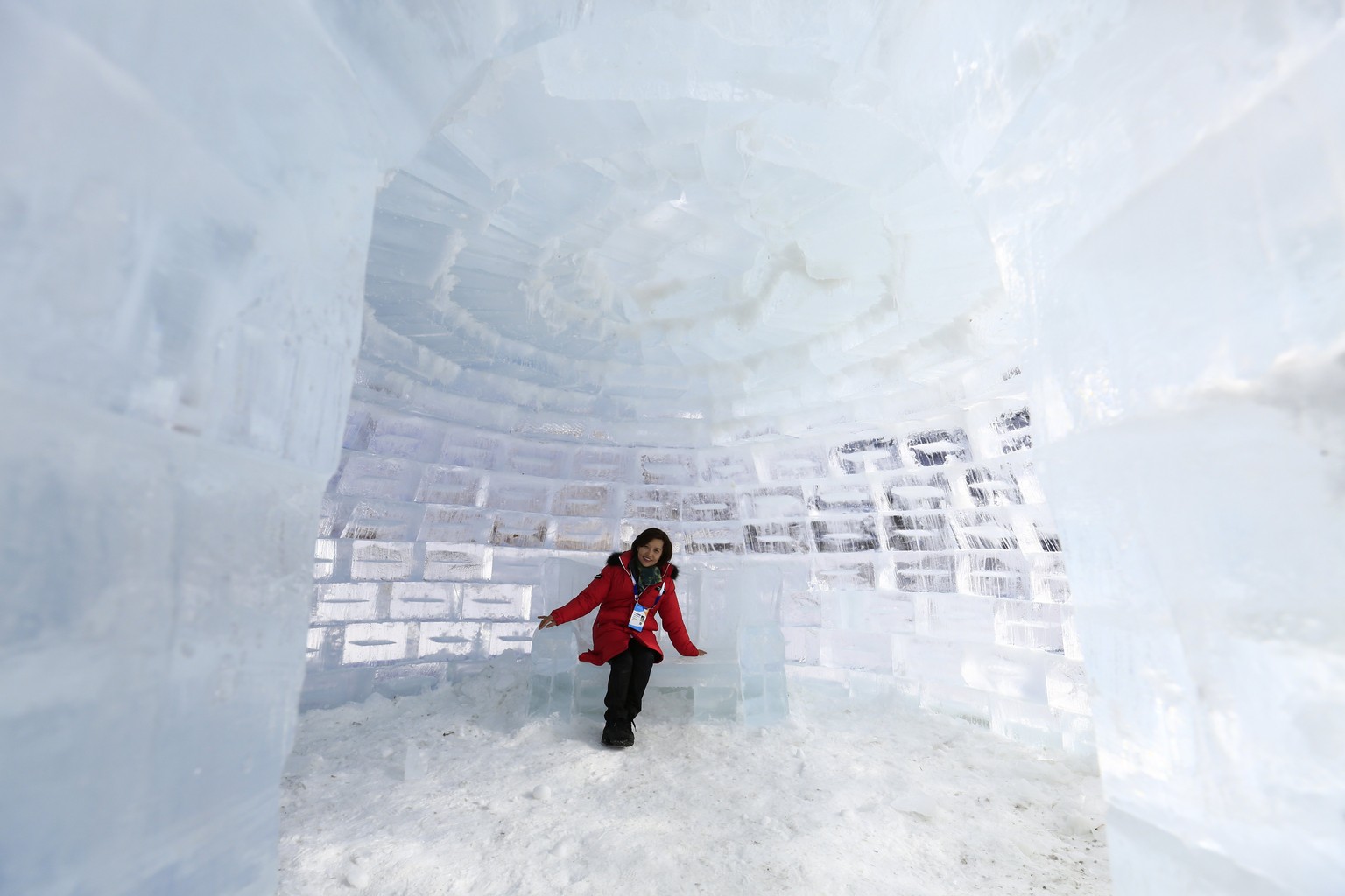 epa06501814 A South Korean woman sits on an ice couch, inside an ice igloo, built on a frozen river bed as part of the Pyeongchang Winter Festival, near the Olympic Stadium, in Pyeongchang county, Sou ...