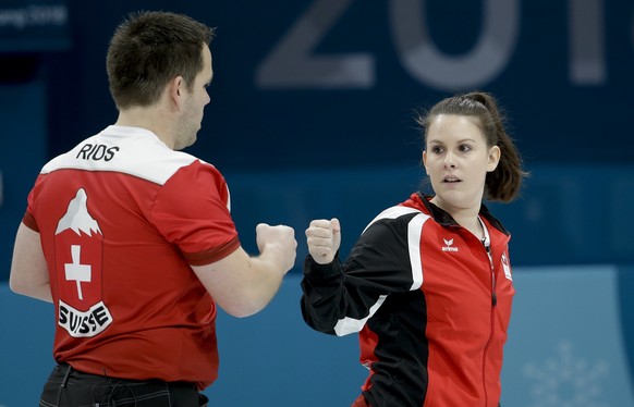 Switzerland Jenny Perret, right, and teammate Martin Rios, celebrate winning a mixed doubles curling match against Olympic Athletes from Russia Anastasia Bryzgalova and Aleksandr Krushelnitckii at the ...