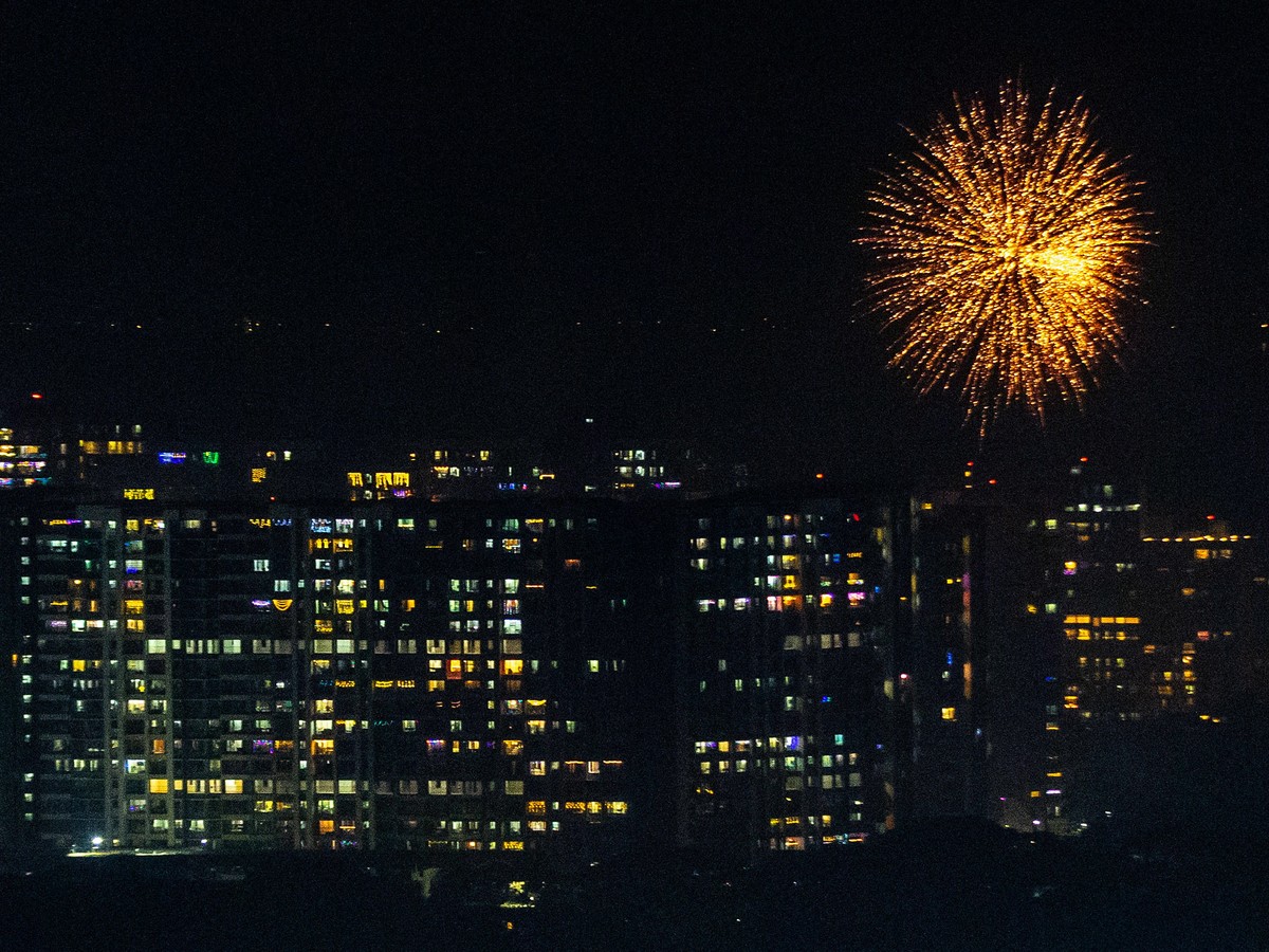 epa10263674 Residential buildings are lit up with lanterns and lights as a firework goes off on the occasion of Diwali festival in Mumbai, India, 24 October 2022. During Diwali, celebrating Kali, the  ...