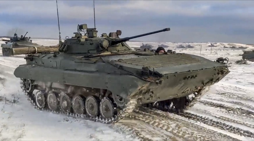 In this photo taken from video and released by the Russian Defense Ministry Press Service on Wednesday, Feb. 2, 2022, Russian and Belarusian armored vehicles drive during a joint military drills at Br ...