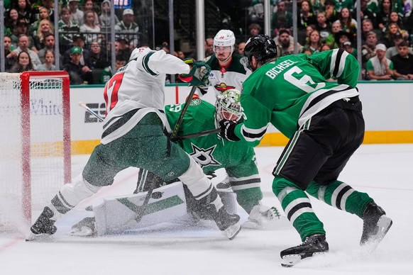 Minnesota Wild left wing Marcus Foligno, left, has his shot blocked by Dallas Stars goaltender Jake Oettinger (29) as Lian Bichsel (6) looks on in the second period of an NHL hockey game Thursday, Apr ...