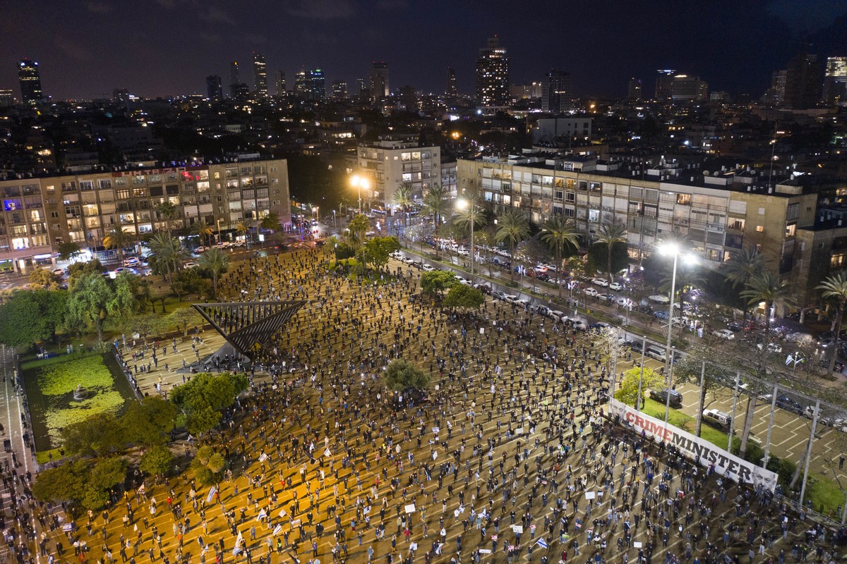 People keep social distance amid concerns over the country's coronavirus outbreak, during "Black Flag" protest against Prime Minister Benjamin Netanyahu and government corruption, at Ra ...