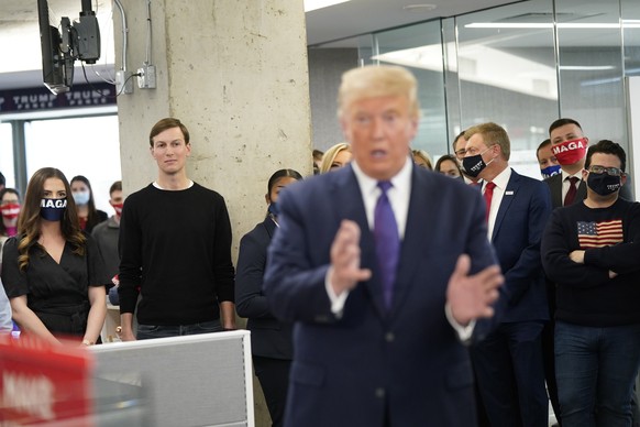 epa08796047 Jared Kushner (2-L), Senior Advisor to the President of the United States looks on as US President Donald J. Trump (C) visits campaign workers at the RNC Annex in Arlington, Virginia, USA, ...