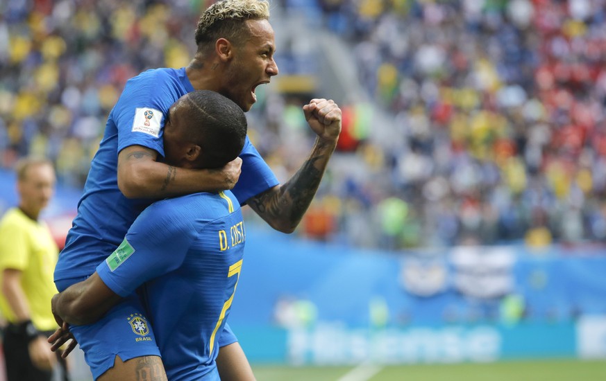 Brazil&#039;s Neymar, top, celebrates with teammate Douglas Costa after scoring his side&#039;s second goal during the group E match between Brazil and Costa Rica at the 2018 soccer World Cup in the S ...