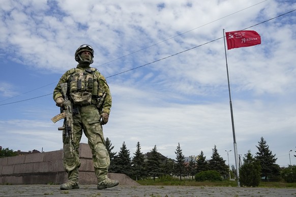 FILE - A Russian soldier guards an area at the Alley of Glory exploits of the heroes - natives of the Kherson region, who took part in the liberation of the region from the Nazi invaders in Kherson, K ...