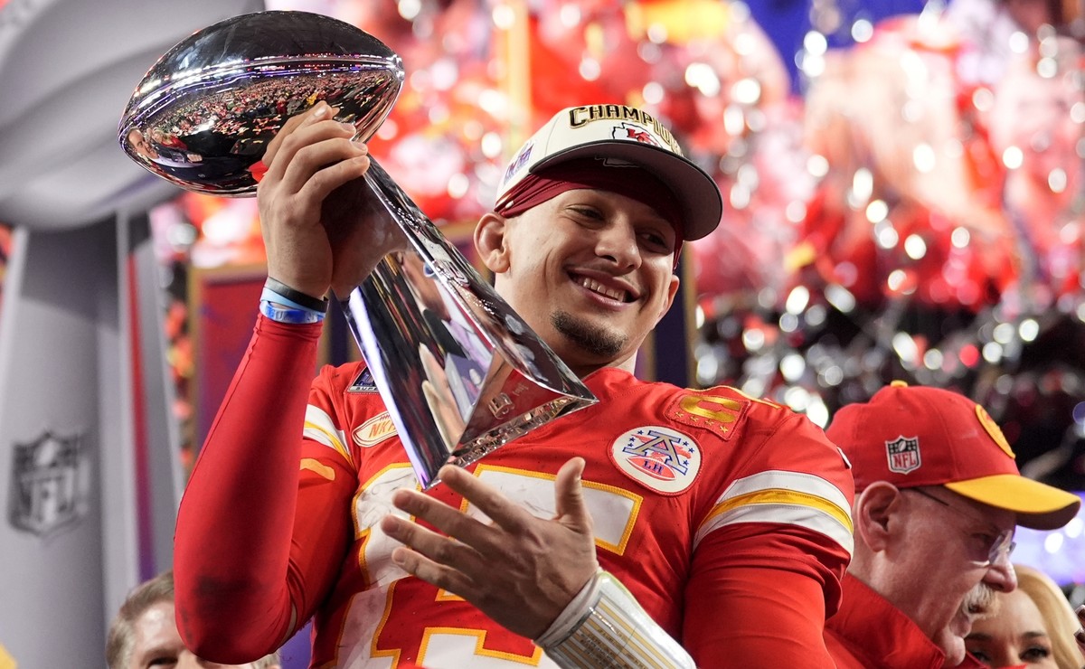 Kansas City Chiefs quarterback Patrick Mahomes celebrates with the trophy after the team's win in overtime during the NFL Super Bowl 58 football game against the San Francisco 49ers on Sunday, Fe ...