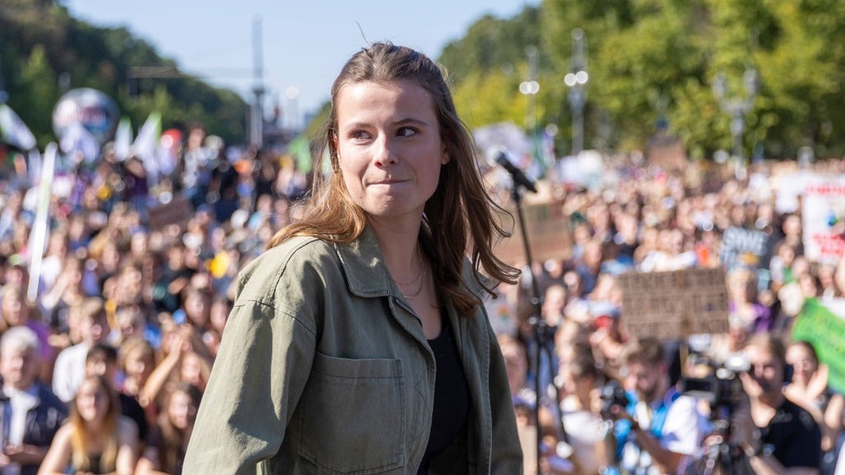 BERLIN, GERMANY - SEPTEMBER 15: Luisa Neubauer, prominent member of the Fridays for Future (FFF) climate action movement speaks to supporters as they gather at the Brandenburg Gate during a worldwide  ...