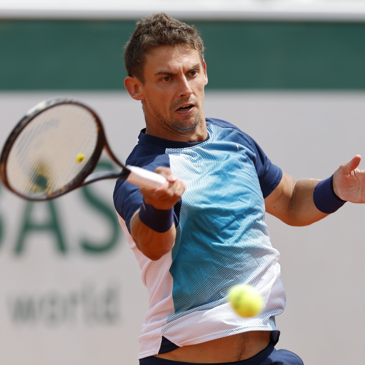 Switzerland's Henri Laaksonen plays a shot against Denmark's Holger Rune during their second round match at the French Open tennis tournament in Roland Garros stadium in Paris, France, Thurs ...