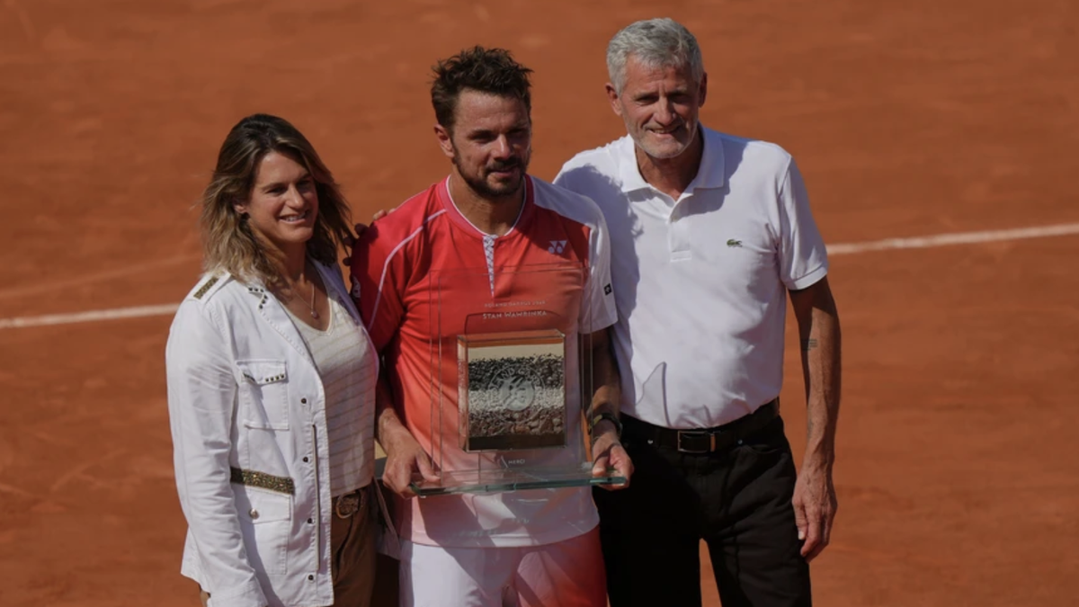 From left: Roland Garros tournament director and former tennis star Amelie Mauresmo, Stan Wawrinka of Switzerland and French tennis federation President Gilles Moretton pose for a picture after the fi ...