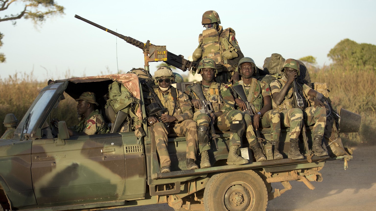 FILE - ECOWAS Senegalese troops hold their position in Barra, across from the Gambian capital Banjul Jan. 22, 2017. West Africa&#039;s regional bloc known as ECOWAS has threatened the use of force in  ...