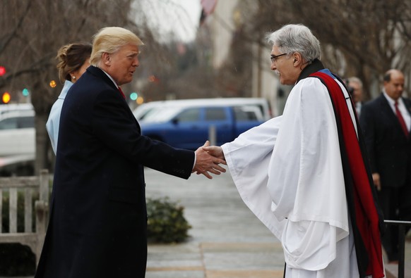 Rev Luis Leon greets President-elect Donald Trump and his wife Melania as they arrive for a church service at St. Johnâs Episcopal Church across from the White House in Washington, Friday, Jan. 20,  ...