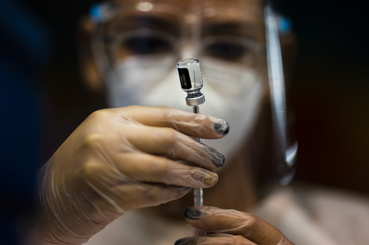 FILE - A nurse prepares a dose of the Pfizer COVID-19 vaccine at the Tomas Dones Coliseum, in Fajardo, Puerto Rico, Jan. 8, 2022. A debate over public health and personal rights intensified on Wednesd ...