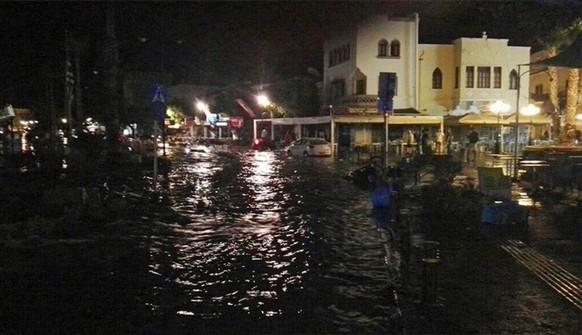 People walk at a flooded coastal road after an earthquake on the Greek island of Kos early Friday, July 21, 2017. A powerful earthquake struck Greek islands and Turkey&#039;s Aegean coast early Friday ...