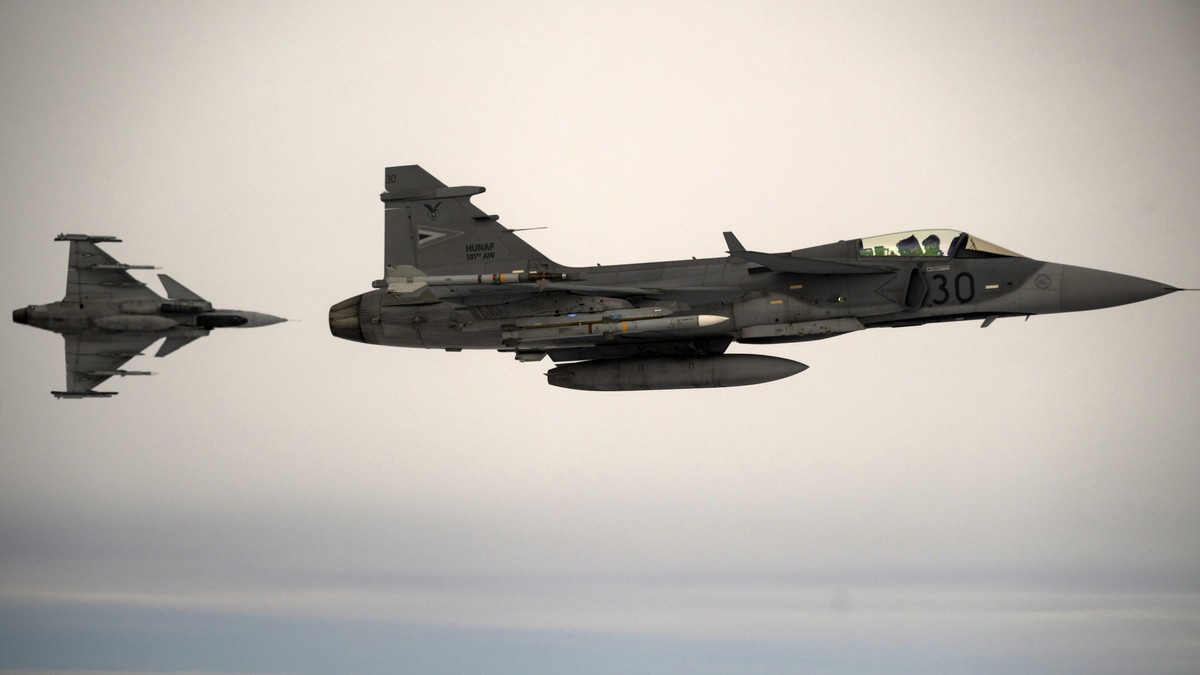 epa12521434 Two JAS-39C Gripen fighter aircrafts of the Hungarian Defense Forces (HDF) fly during an alert response simulation at the Siauliai Air Base of NATO's Baltic Air Policing (BAP) mission ...