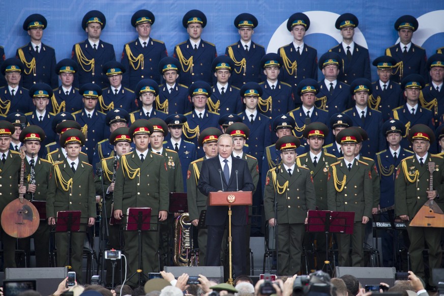 Russian President Vladimir Putin, center, delivers a speech at the opening of the Army-2015 international military show features the latest Russian weapons in Kubinka, outside Moscow, Russia, Tuesday, ...