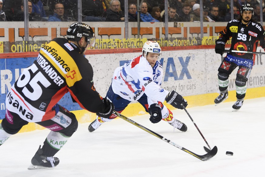 Berns Ramon Untersander, links, und Zuercher Lauri Korpikoski, Mitte, kaempfen um den Puck, an der Seite von Berns Eric Blum, rechts, im ersten Eishockey Playoff-Halbfinalspiel der National League zwi ...