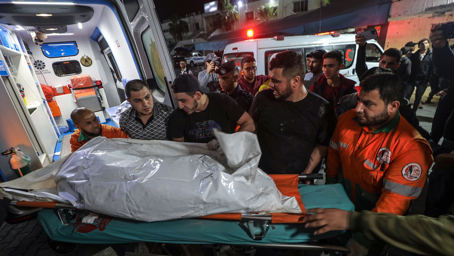 epaselect epa10616278 Palestinians carry the body of a member of Islamic Jihad movement in Al Shifa hospital after Isreli air strikes in Gaza City, 09 May 2023. Israel carried out several attacks agai ...