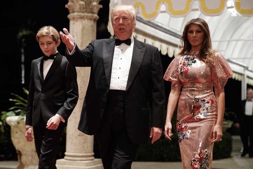 President Donald Trump, first lady Melania Trump, and their son Barron arrive for a New Year&#039;s Eve gala at his Mar-a-Lago resort Sunday, Dec. 31, 2017, in Palm Beach, Fla. (AP Photo/Evan Vucci)