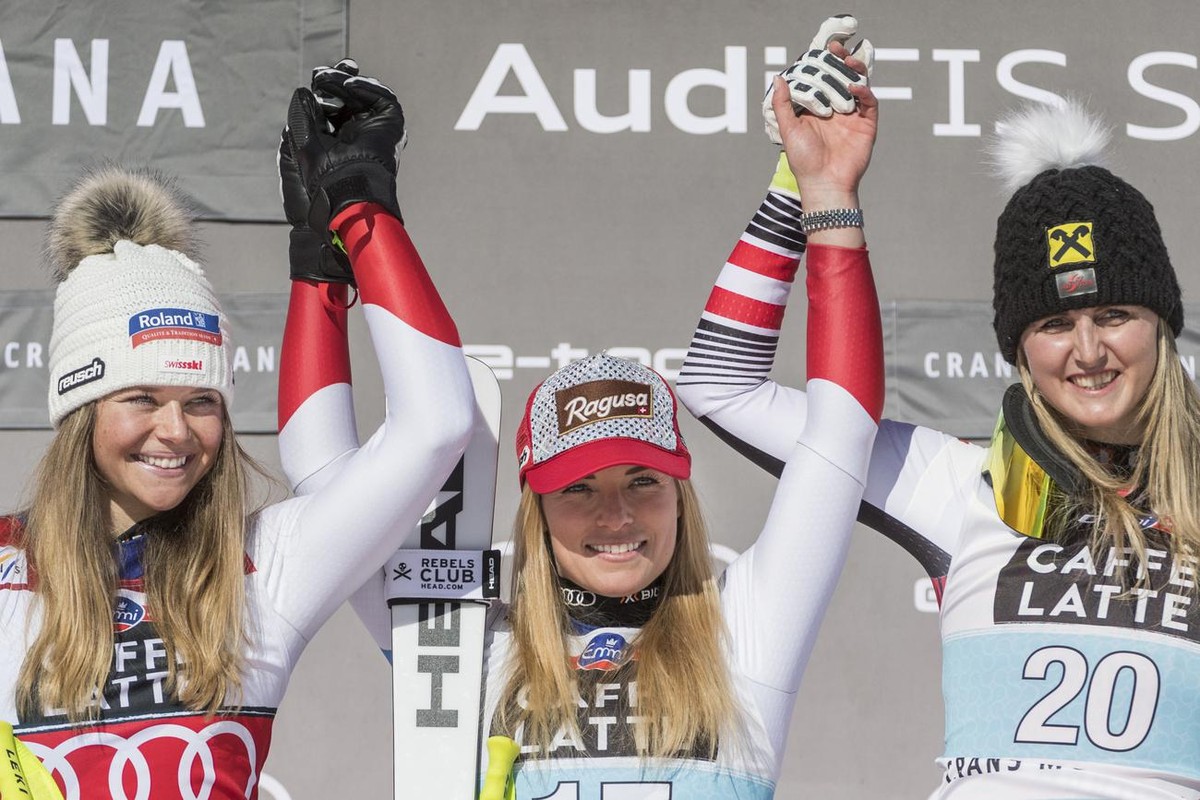 Corinne Suter from Switzerland as second, Lara Gut - Behrami from Switzerland as the winner of the race and Nina Ortlieb from Austria as third, from left, celebrate during the flower ceremony in the f ...