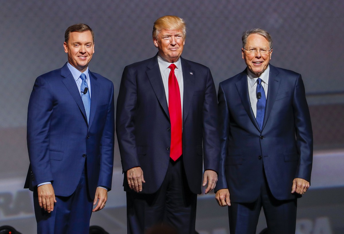 epa05933800 US President Donald J. Trump (C) appears with NRA leaders Wayne LaPierre (R) and Chris Cox (L) before speaking to the National Rifle Association Leadership Forum at the Georgia World Congr ...