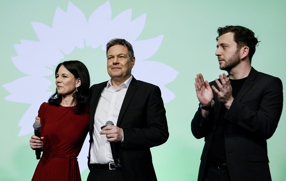 epa11919510 Top candidate for the German federal parliamentary elections of the Green Party (Die Gruenen), German Minister for Economy and Climate Robert Habeck (C), reacts on stage alongside German F ...