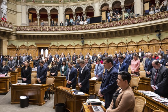 epa09791716 Members of the Grand Chamber of the Swiss Parliament observe a minute of silence to remember the victims of the war in Ukraine, on the first day of the spring session of the Swiss parliame ...