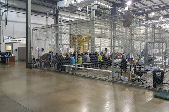 epa06819209 An undated handout photo made available on 18 June 2018 by the US Customs and Border Patrol showing people inside a United States Border Patrol Processing Center in McAllen, Texas, USA. Me ...