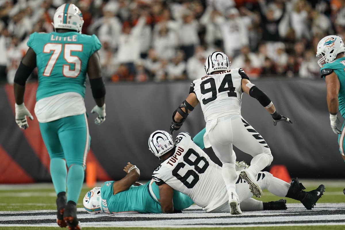 Miami Dolphins quarterback Tua Tagovailoa (1) is sacked by Cincinnati Bengals' Josh Tupou (68) during the first half of an NFL football game, Thursday, Sept. 29, 2022, in Cincinnati. Tagovailoa s ...